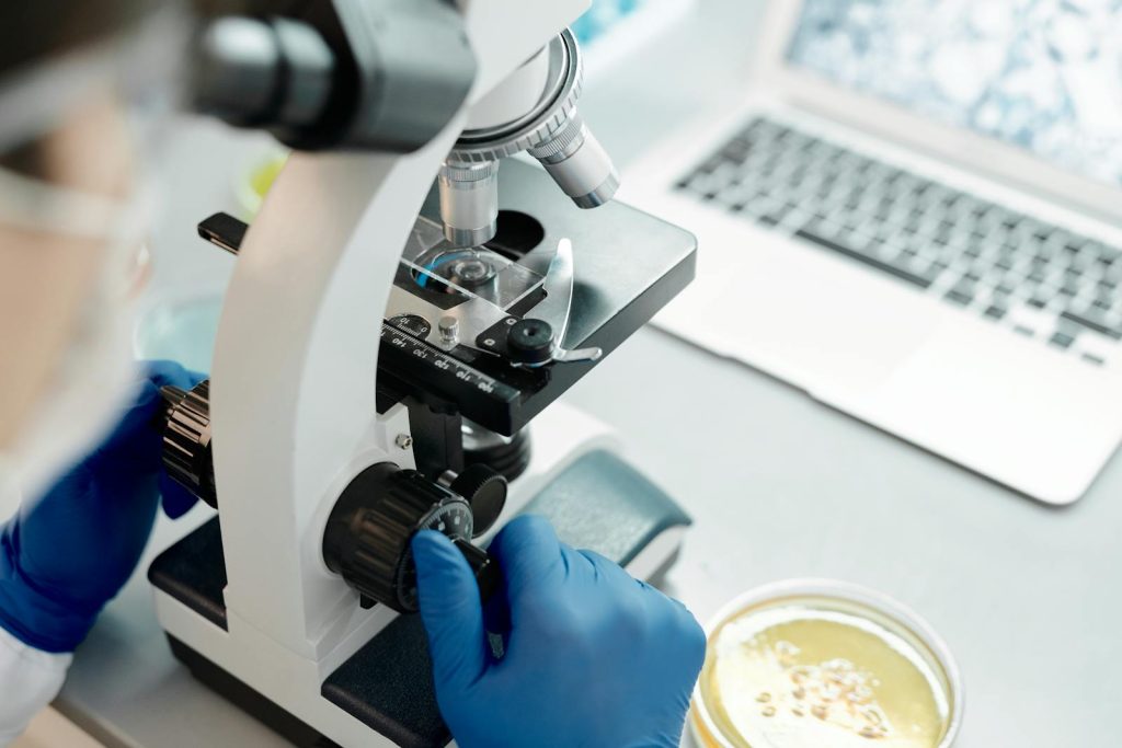 Close-Up Shot of a Scientist Using a Microscope