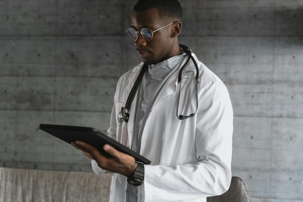 Doctor reviewing patient health data on a tablet in real-time]